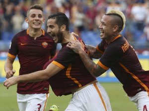 AS Roma's Manolas celebrates after scoring with teammates Nainggolan and Digne during their Italian Serie A soccer match against Carpi in Rome